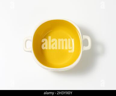 Empty yellow soup plate on white table, top view Stock Photo