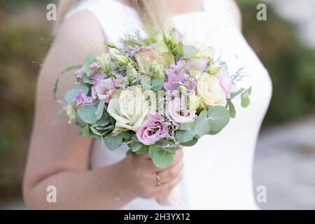 Beautiful wedding bouquet in the hands of the bride Stock Photo
