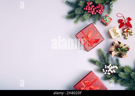Frame of twigs christmas tree, brown natural pine cones and red berries on snow with space for text. Top view, flat lay Stock Photo