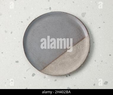 empty ceramic plate on grey kitchen table, top view Stock Photo