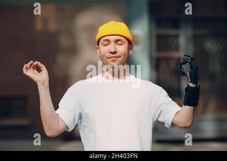 Man with artificial limb of hand meditating Stock Photo