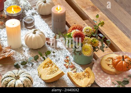Festive table setting with pumpkins and chrysanthemum flowers. Stock Photo