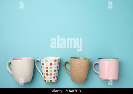 Stack of empty ceramic cup on a blue background, flat lay Stock Photo