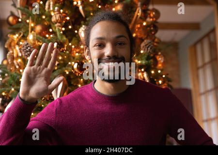 Smiling biracial man talk on video call from home Stock Photo