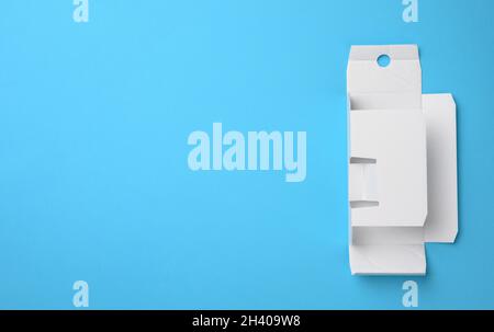 Protective paper from under a box with a perfume, template from white corrugated cardboard, blue background Stock Photo