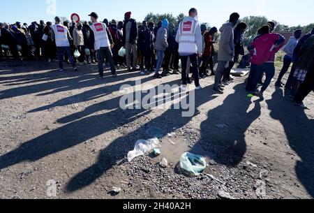 Care4Calais volunteers arrive at a makeshift camp in Calais, France, to distribute food and look after the welfare of migrants sleeping rough in the area. Picture date: Thursday October 28, 2021. Stock Photo
