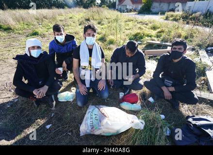 Abbas (centre), a student nurse nurse who was forced to leave Syria amid the bloody civil war and is now sleeping rough in Calais, France, said he wants to help people in the UK. Picture date: Thursday October 28, 2021. Stock Photo