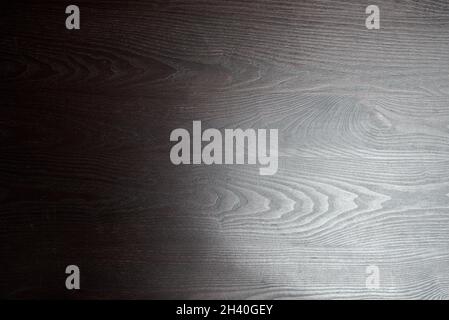 Dark wooden table with natural light from the right Stock Photo