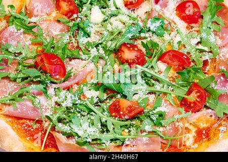 Overhead close-up shot of textured Rocket and ham pizza Stock Photo