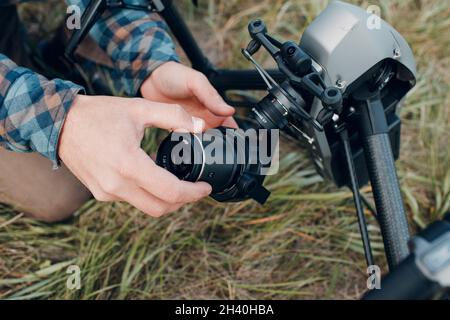 New York, USA - SEPTEMBER 18, 2021: Man pilot checking DJI Inspire 2 quadcopter drone and putting on camera lens before aerial f Stock Photo
