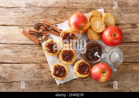 apple butter prepared from organic apples and toasts closeup on the table. Horizontal top view from above Stock Photo
