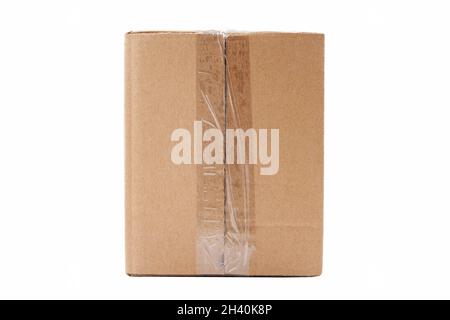 One single simple clear taped rectangle brown carton box parcel, blank closed package isolated on white background cut out, nobody. Product shipping, Stock Photo