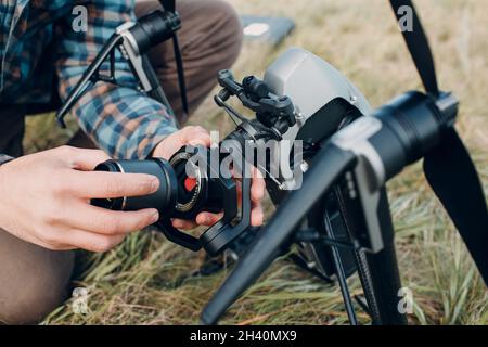 Man pilot checking quadcopter drone before aerial flight and filming. Stock Photo