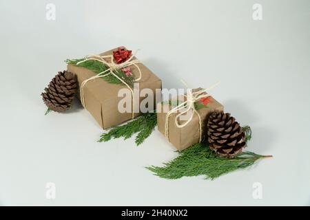 Noel gift boxes with pine cone on white background, isolated close up copy space photo Stock Photo