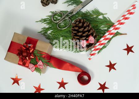 Christmas gift concept idea photo with pine cone leaf or red white star or pipette or ribbon on white background top view Stock Photo