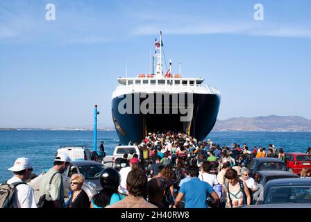 Agistri island, Greece Dramatic view of the local ferry, docked at a small jetty  Travelers board the boat  Landscape aspect shot  Copy space Stock Photo