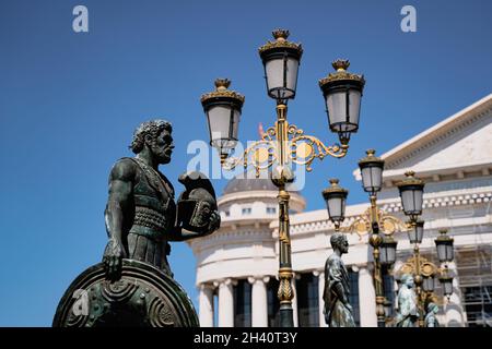 SKOPJE, NORTH MACEDONIA - AUGUST 19, 2021: Bronze statue of historical figures on Vardar river bridge in Skopje Stock Photo