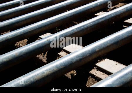 Close-up of a metal cattle grid with concrete supports Stock Photo