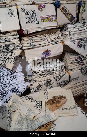 TOKAT, TURKEY - AUGUST 6, 2021: Shop shelves with Tokat style hand printed textile cotton fabrics next to a wooden pattern mold crafted in a centuries Stock Photo