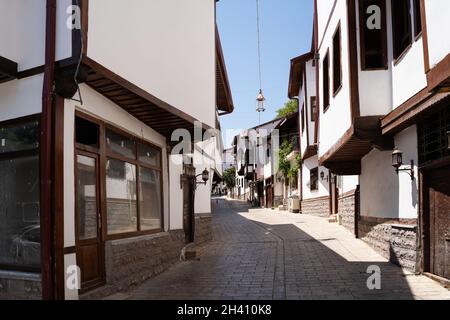 TOKAT, TURKEY - AUGUST 6, 2021: Narrow streets of Tokat old city center with white buildings and wooden traditional architecture Stock Photo