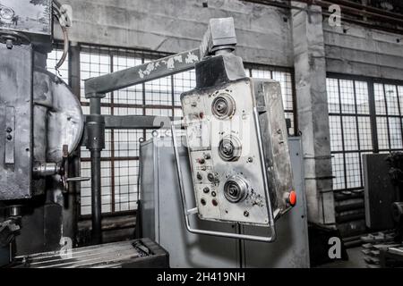 Old control panel of milling machine equipment in the workshop of industrial plant. Stock Photo