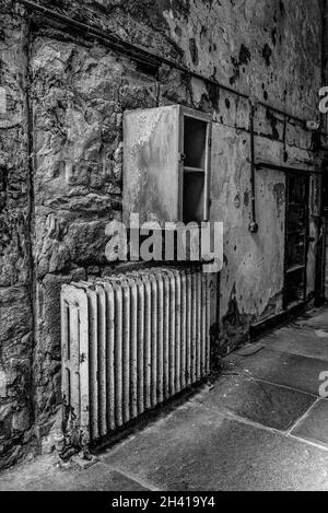 Old rusty radiator and little locker in an old building, Eastern State Penitantiary, USA Stock Photo