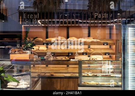 Bakery showcase with assorted baked goods, breads and loaves Stock Photo
