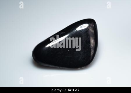 natural black shungite cabochon on background Stock Photo