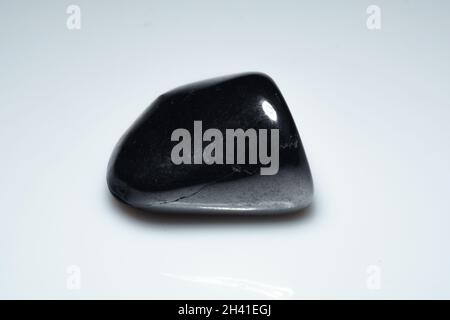 natural black shungite cabochon on background Stock Photo