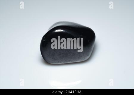 natural black shungite cabochon on background Stock Photo