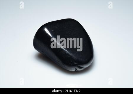 natural black shungite cabochon on background Stock Photo