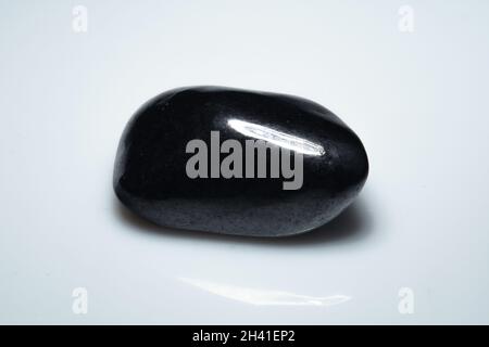natural black shungite cabochon on background Stock Photo
