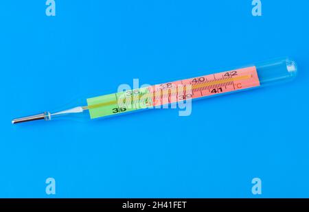 Medical thermometer on blue background Stock Photo