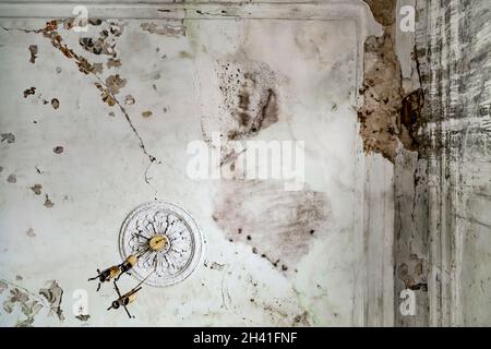Rain water leaks on the room ceiling causing damage Stock Photo