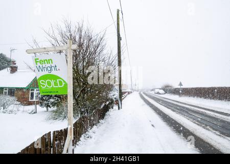 Woodbridge Suffolk UK February 07 2021: Real estate sign showing the house has been sold in a snowy winter landscape Stock Photo