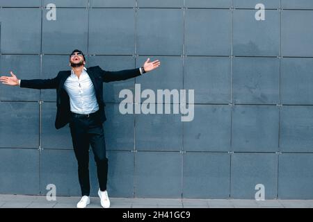 Arabic guy in business center stands smiling walking slow Stock Photo