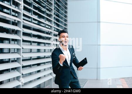 Young arabic man demonstrate shows YES business center Stock Photo