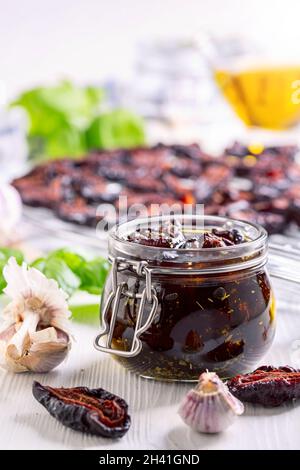 Homemade dried plums with Italian herbs and olive oil. Stock Photo