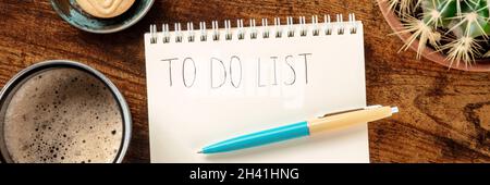 To do list panorama. A notebook with a blue pen and with coffee, shot from above Stock Photo