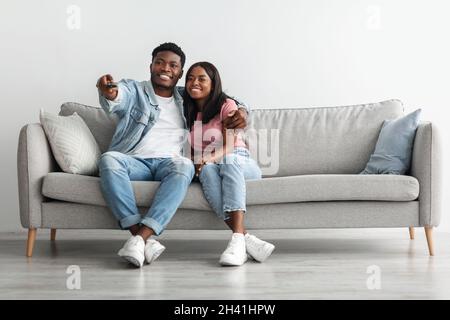 African American couple spending weekend together watching tv Stock Photo