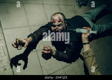 Zombie male makeup for halloween concept. Blood on skin face Stock Photo