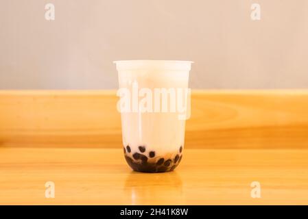 Green tea with bubbles or pearls, also known for its anglicized bubble tea or also as boba, is a flavored sweet tea drink invented in Taiwan Stock Photo