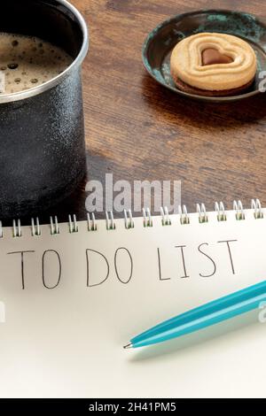 To Do List, handwritten words on a paper notepad, with a turquoise blue pen Stock Photo