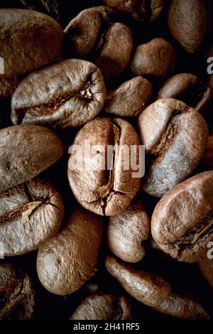 Bird-eye view of zoomed in fragrant and aromatic roasted coffee beans. Coffee, beverage, producing Stock Photo
