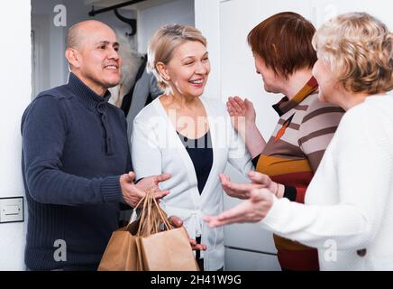 Mature friends are visiting their friend Stock Photo