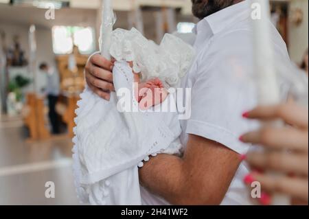 sacrament of baptism the priest baptizes the child with anointing Stock Photo