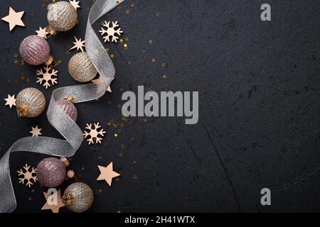 Christmas background with gold and silver decorations on black