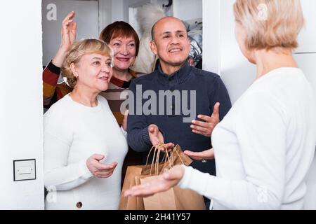Mature friends are visiting their friend Stock Photo