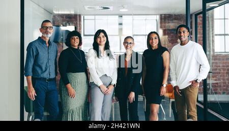 Portrait of a team of creative businesspeople standing together. Group of successful businesspeople smiling at the camera while standing next to each Stock Photo