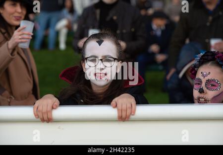 Ascot, Berkshire, UK. 30th October, 2021. Young racegoers have their faces painted and dress up for Halloween. It was a busy day at Ascot Racecourse today for the first of the jumps season. Families also enjoyed the funfair and Halloween activities for the children. Credit: Maureen McLean/Alamy Stock Photo